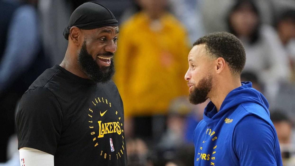 Los Angeles Lakers forward LeBron James (left) and Golden State Warriors guard Stephen Curry (right) talk before the game at Chase Center.