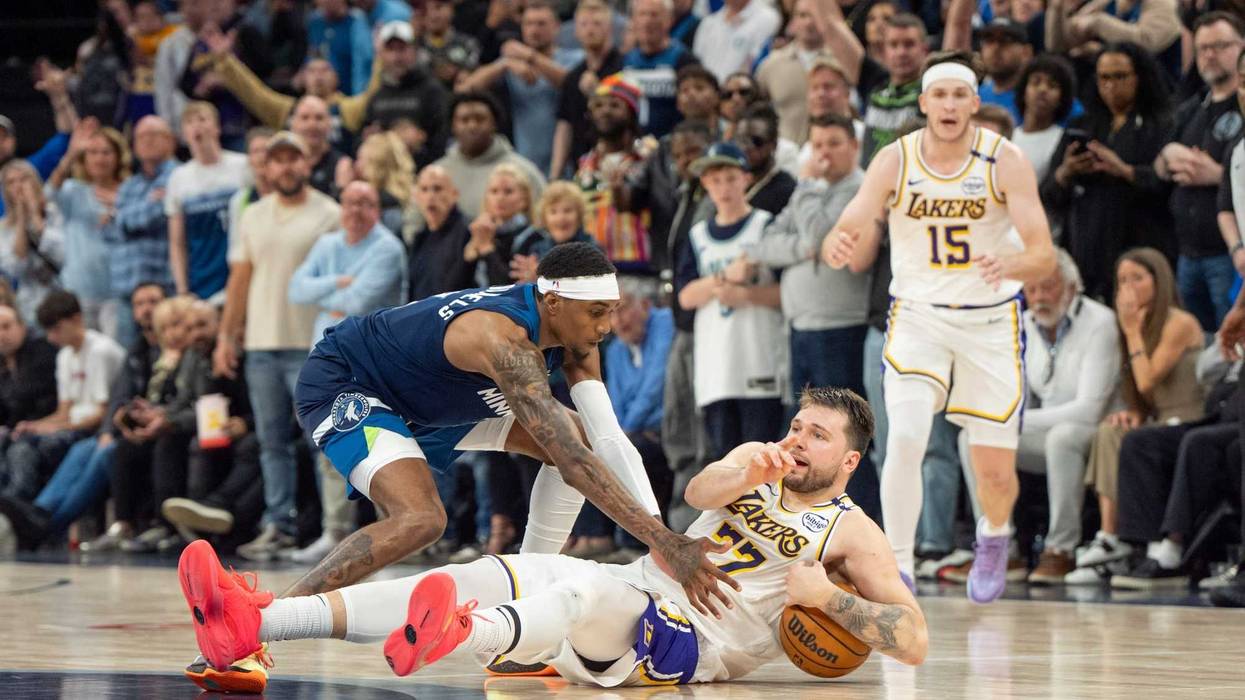 Los Angeles Lakers guard Luka Doncic (77) calls a timeout after stumbling on the defense of Minnesota Timberwolves forward Jaden McDaniels (3) in the fourth quarter during game four of first round for the 2025 NBA Playoffs at Target Center. The NBA after the game said it should have been called a foul on McDaniels.