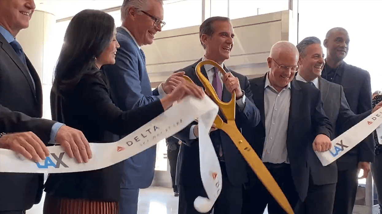 Los Angeles Mayor Eric Garcetti cutting the ribbon at Delta's unveiling of its new terminal facility at Los Angeles International Airport on March 28, 2022.