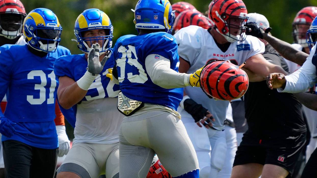 Los Angeles Rams defensive tackle Jonah Williams (92) attempts to hold back Rams defensive tackle Aaron Donald (99) as a third scuffle escalates into a brawl during a joint preseason NFL football camp practice between the Cincinnati Bengals and the Rams in Cincinnati, Thursday, Aug. 25, 2022. Practice was ended early after the third scuffle turned into a broader fight between players on both teams.