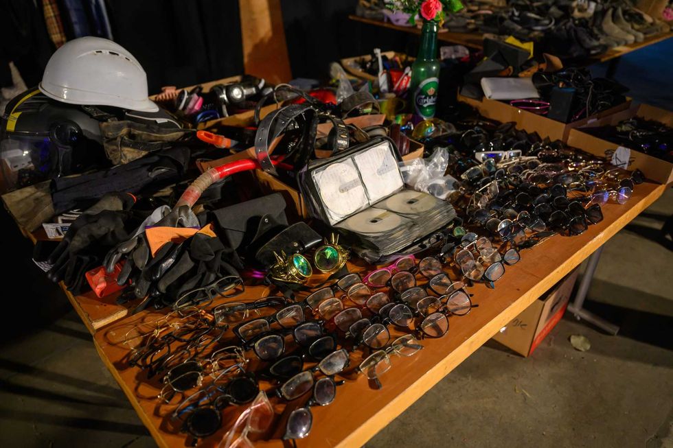 "Lost and found" tables display personal items collected from the Nova festival site at the