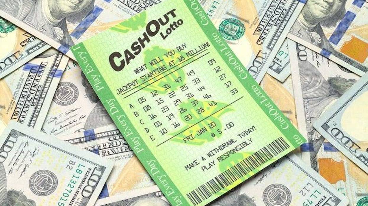 Lottery ticket sitting on a pile of cash
