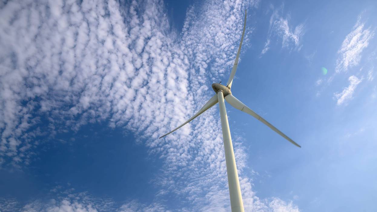 Low angle shot of offshore wind turbine.