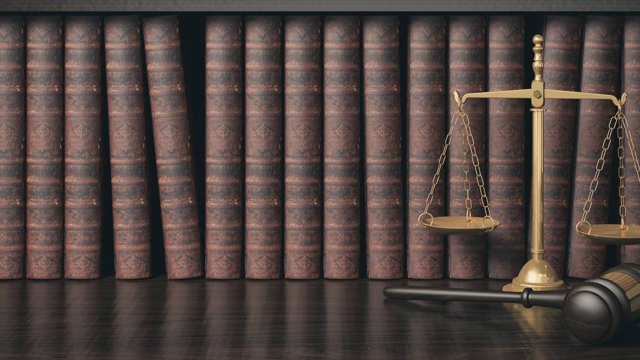Low key filter law bookshelf with wooden judge's gavel and golden scale