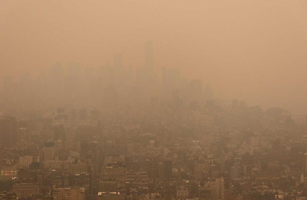 Lower Manhattan is barely visible as heavy smoke shrouds Manhattan in a view looking south from the Empire State Building as the sun sets on June 6, 2023, in New York City