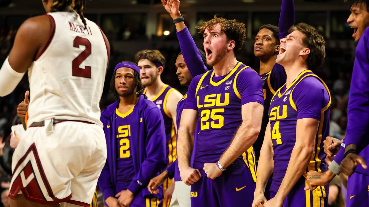 LSU Tigers bench players forward Adam Benhayoune (25) and guard Trace Young (14) celebrate a play