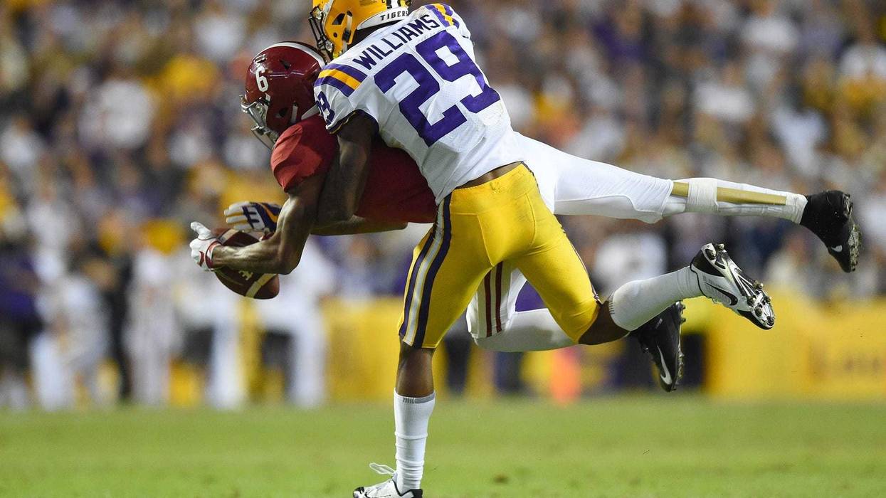 LSU Tigers cornerback Greedy Williams (29) breaks up a pass intended for Alabama Crimson Tide wide receiver DeVonta Smith (6) during the third quarter at Tiger Stadium.