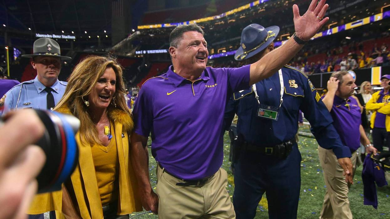 LSU Tigers head coach Ed Orgeron celebrates with wife Kelly Orgeron after a victory against the Georgia Bulldogs in the 2019 SEC Championship Game at Mercedes-Benz Stadium.