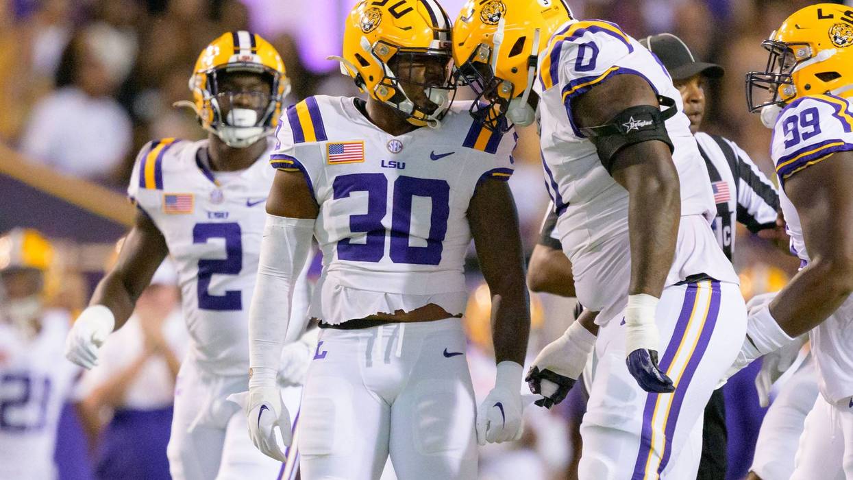 LSU Tigers linebacker Greg Penn III (30) celebrates with defensive tackle Maason Smith (0) after a sack