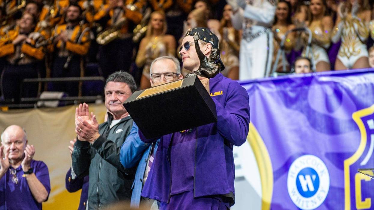 LSU Tigers quarterback Joe Burrow hoists the Heisman Trophy during the LSU Tigers College Football Playoff national championship celebration and parade.