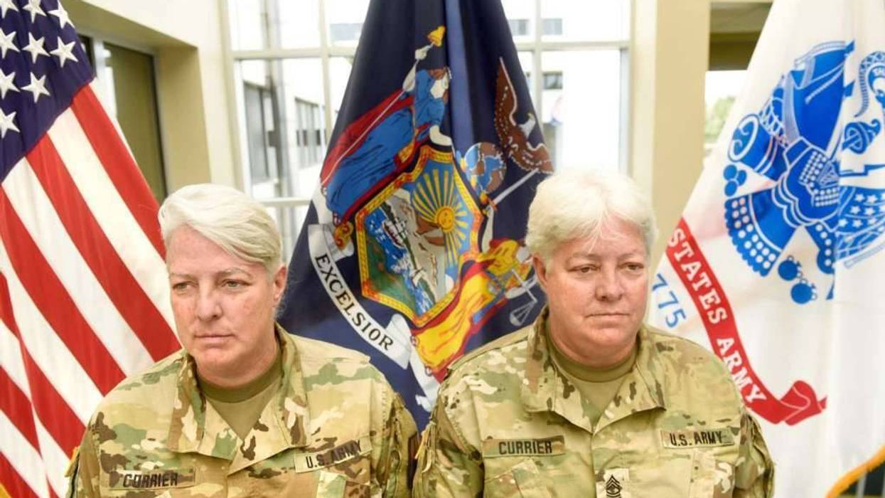 Lt. Col. Lynn Currier, an information management branch manager, and Master Sgt. Lisa Currier, a senior logistics officer, assigned to the New York National Guard Headquarters here, prepare for Lynn's retirement from the New York National Guard during a c