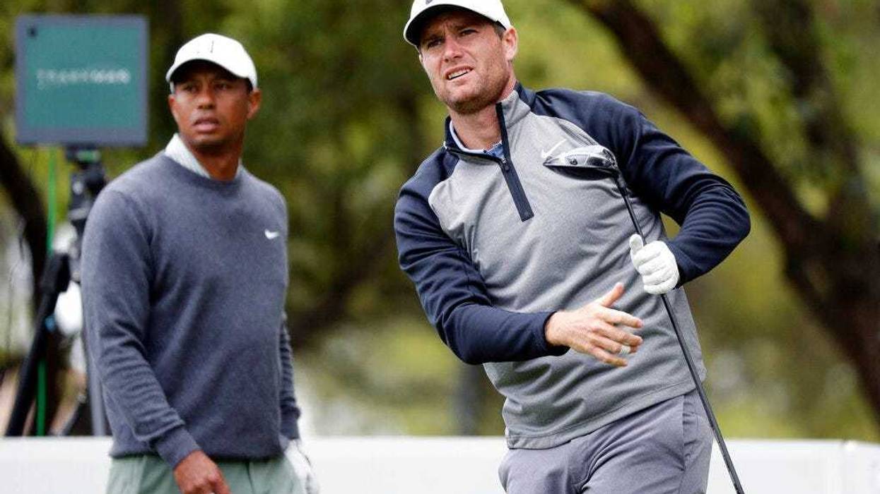 Lucas Bjerregaard, right, watches his drive on the eighth hole as Tiger Woods, left, looks on during quarterfinal play at the Dell Technologies Match Play Championship golf tournament, Saturday, March 30, 2019, in Austin, Texas. Bjerregaard won the match.