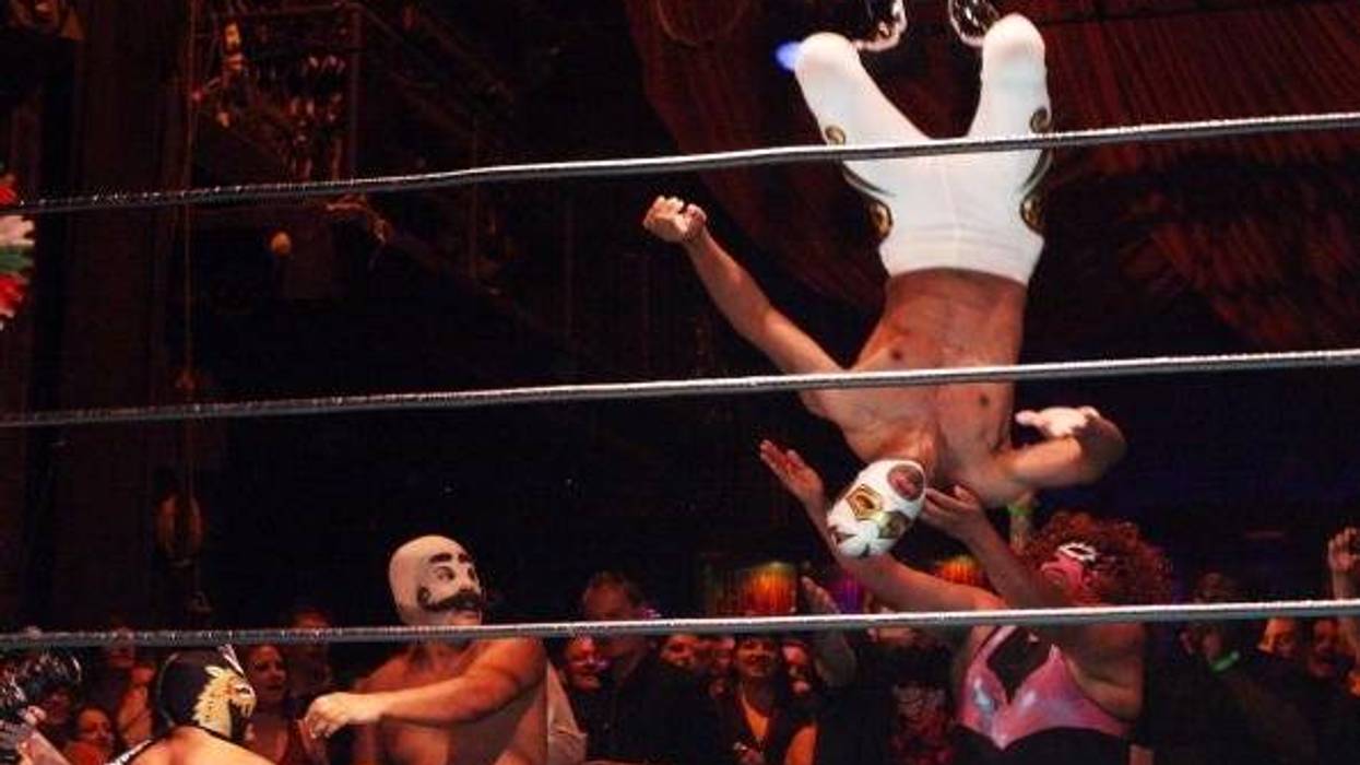 Luchadores, traditional Mexican wrestlers, fly over the ropes and into the audience as they perform at the Lucha Vavoom Cinco de Mayan! show at the Mayan Theater on Cinco de Mayo, May 5, 2009 in Los Angeles, California. Lucha Vavoom combines elements of t