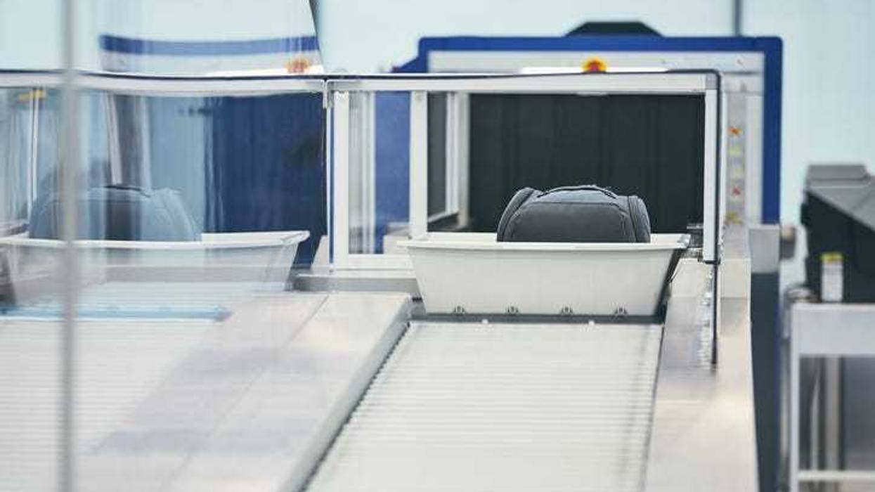 Luggage going through an X-ray machine.