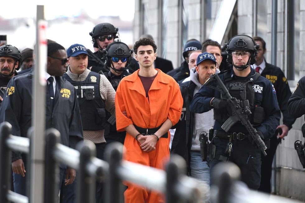 Luigi Mangione, a suspect in the fatal shooting of UnitedHealthcare CEO Brian Thompson, is escorted by police, Thursday, Dec. 19, 2024, in New York