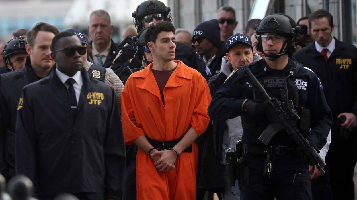 Luigi Mangione, suspect in the killing of UnitedHealthcare CEO Brian Thompson in New York City, arrives at a heliport with members of the NYPD on December 19, 2024
