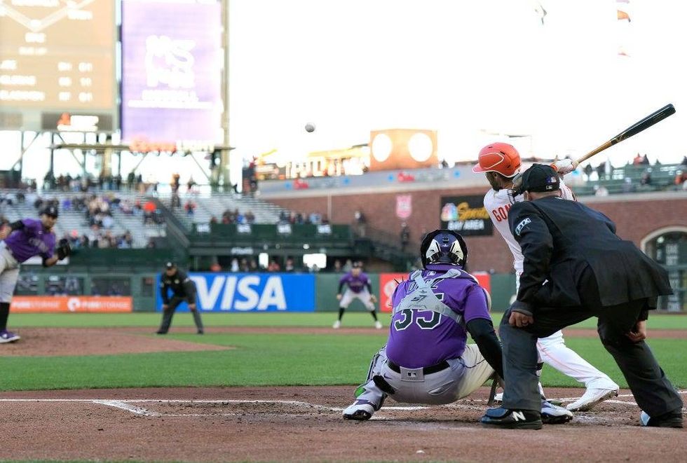 Luis Gonzalez of the San Francisco Giants hits an RBI infield single against the Colorado Rockies in the bottom of the second inning at Oracle Park on May 10, 2022 in San Francisco, California.