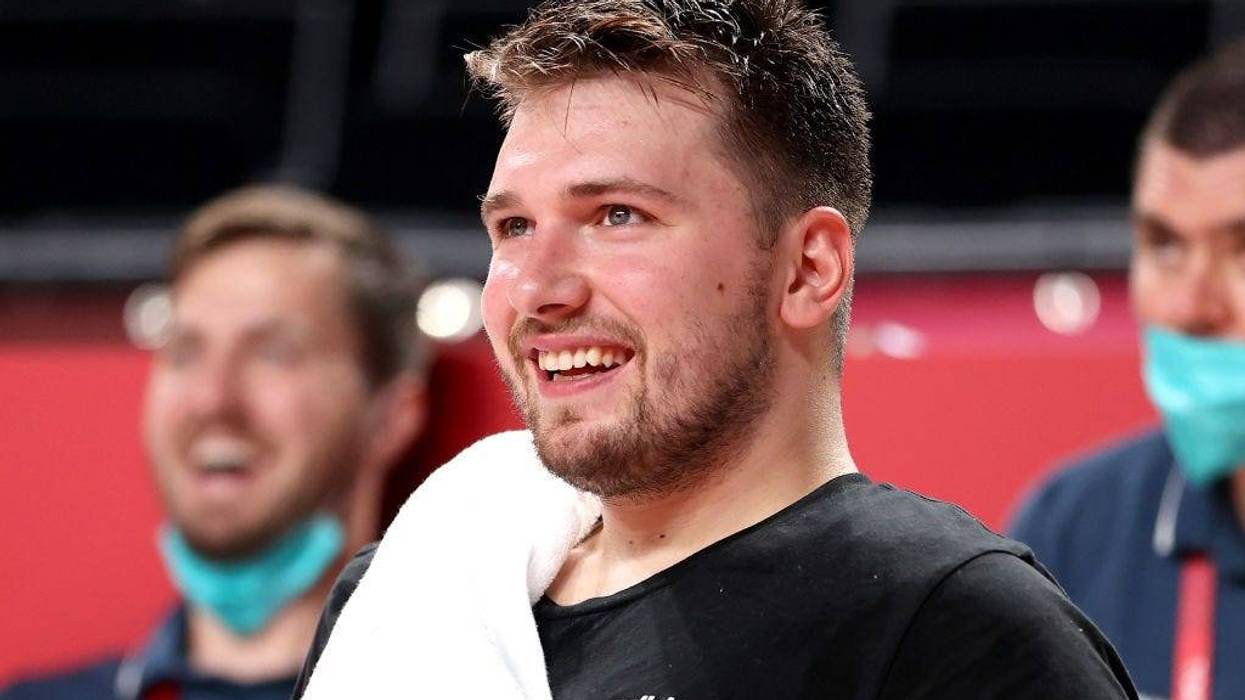Luka Doncic #77 of Team Slovenia smiles from the bench against Japan during the second half of a Men's Preliminary Round Group C game on day six of the Tokyo 2020 Olympic Games at Saitama Super Arena on July 29, 2021 in Saitama, Japan.