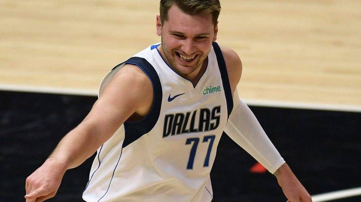 Luka Doncic #77 of the Dallas Mavericks reacts with fans in celebration of a Mavericks basket in the first quarter against the LA Clippers during game two of the Western Conference first round series at Staples Center on May 25, 2021 in Los Angeles, California.
