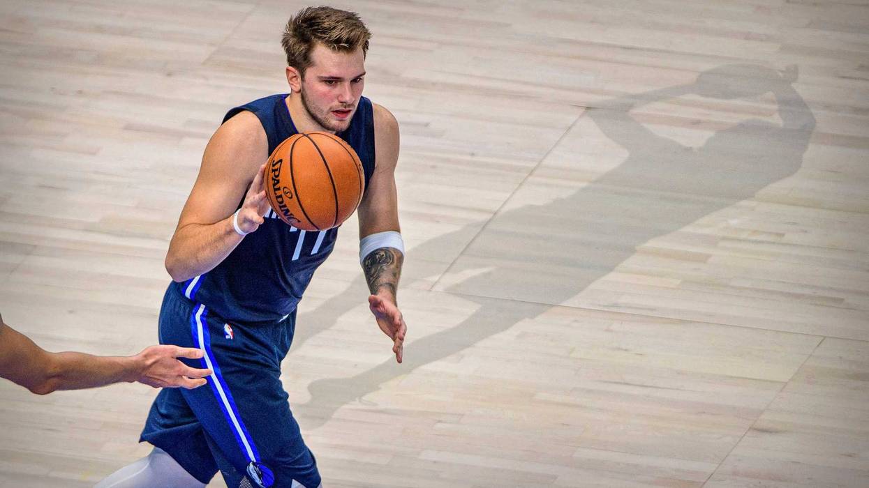 Luka Doncic brings the ball up the court