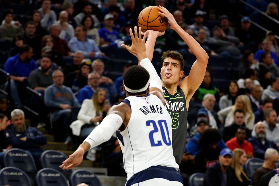 Luka Garza #55 of the Minnesota Timberwolves shoots the ball while Richaun Holmes #20 of the Dallas Mavericks defends in the fourth quarter at Target Center on January 31, 2024 in Minneapolis, Minnesota. The Timberwolves defeated the Mavericks 121-87.