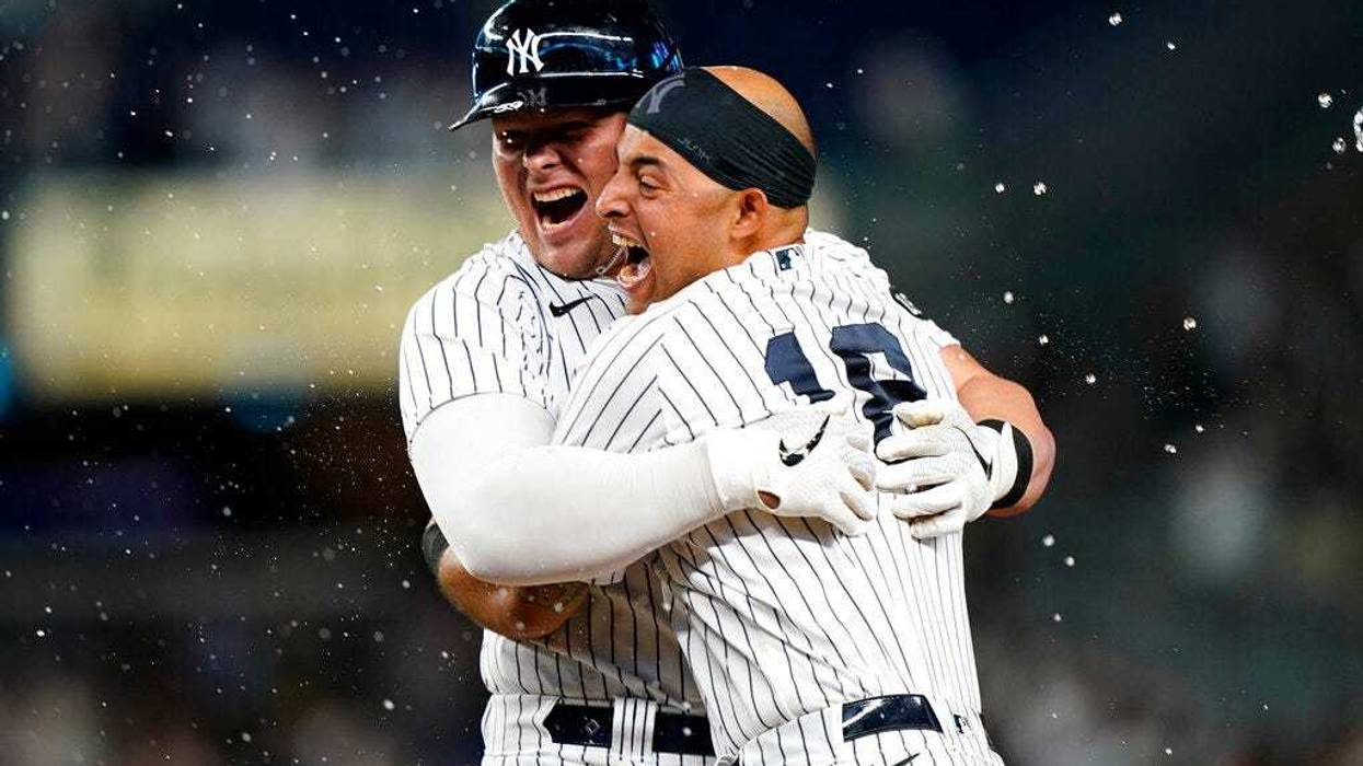 Luke Voit celebrates with Yankees Rougned Odor after hitting a ninth-inning, walk-off RBI single