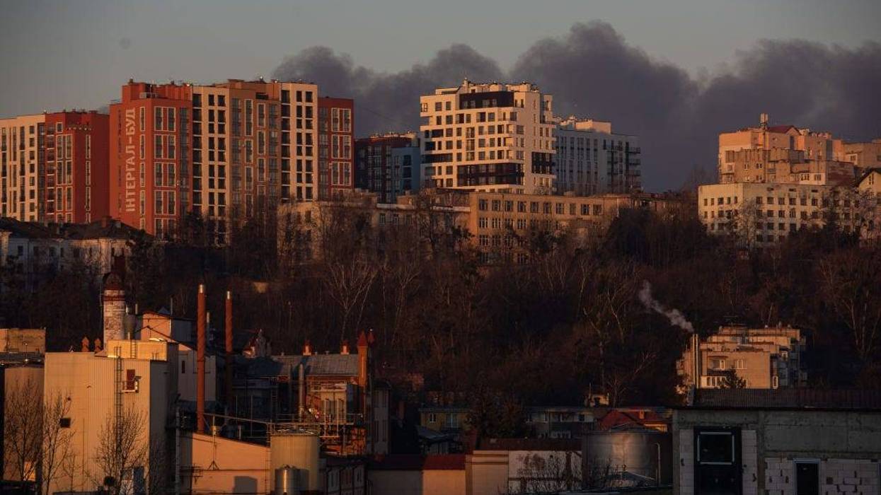 LVIV, UKRAINE - MARCH 18: Smoke is seen above apartment blocks on March 18, 2022 in Lviv, Ukraine. Lviv's mayor said on Telegram that the airport was not hit, but an area nearby.