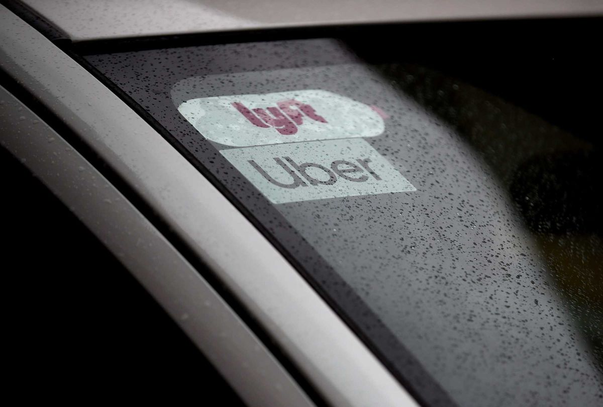 Lyft and Uber decals on car windshield