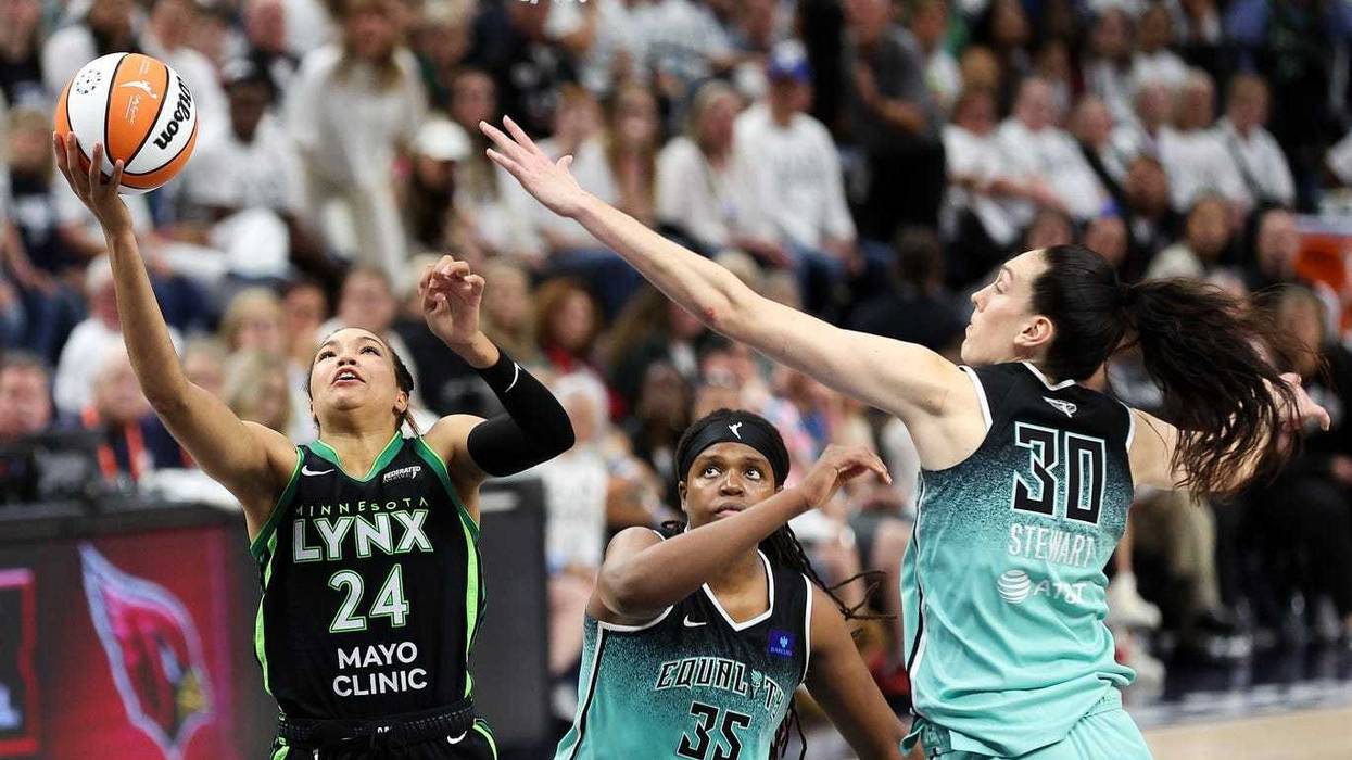 Lynx forward Napheesa Collier (24) shoots as New York Liberty forward Jonquel Jones (35) and forward Breanna Stewart (30) defend during the second half of game four of the 2024 WNBA Finals at Target Center.