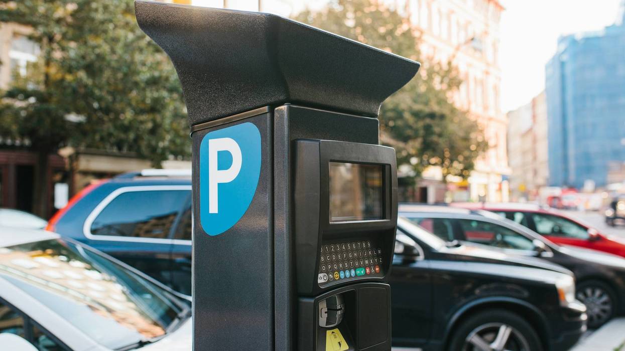 Machine for paying parking. Close-up - machine for paying parking on background of blurry cars