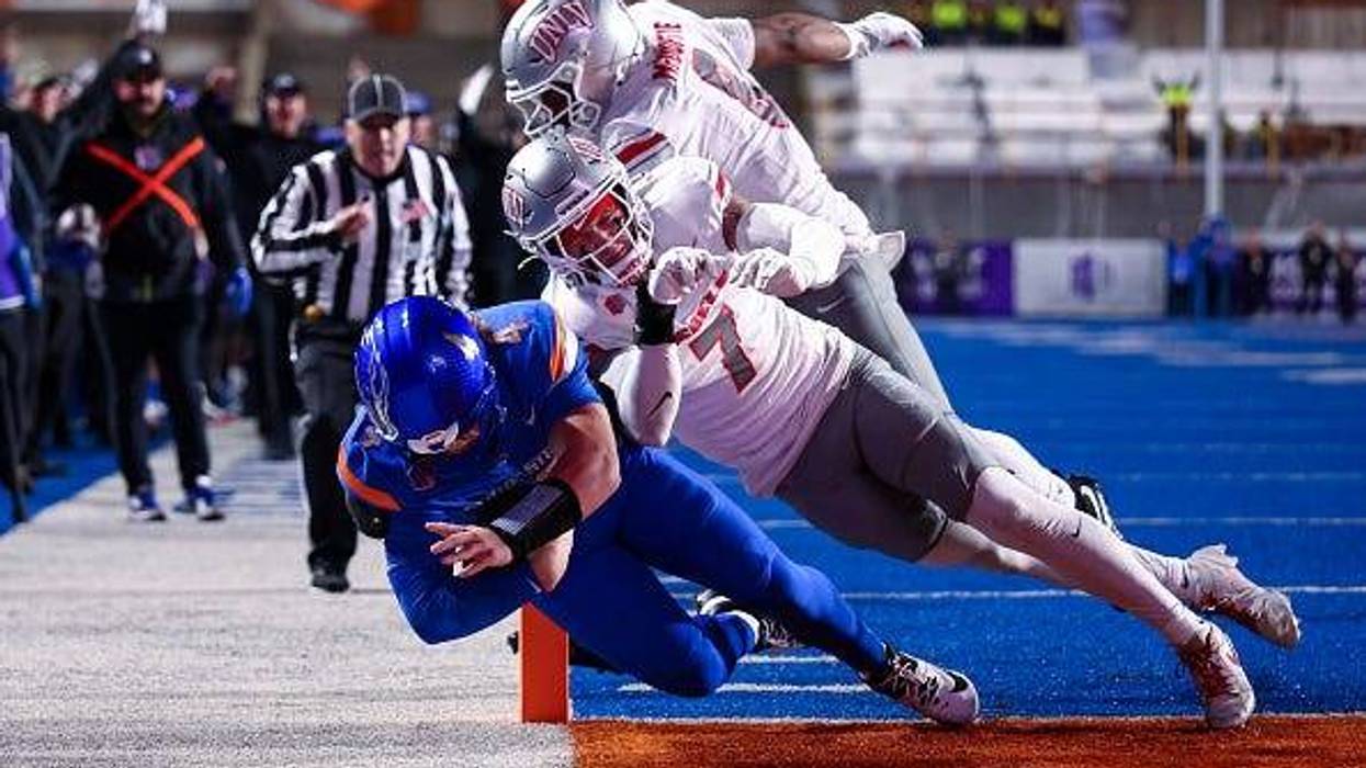 Maddux Madsen #4 of the Boise State Broncos dives for a touchdown against Jake Pope #7 of the UNLV Rebels at Albertsons Stadium on December 5, 2025 in Boise, Idaho.