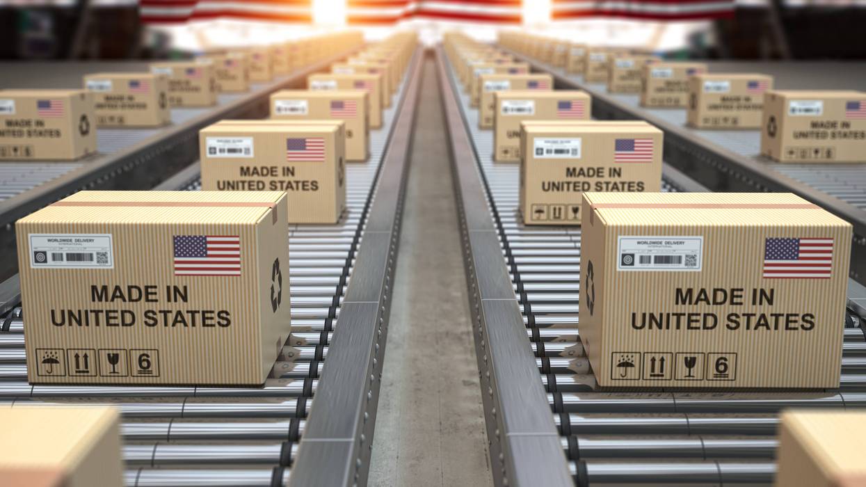 Made in USA United States. Cardboard boxes with text made in USA and american flag on the roller conveyor. 3d illustration