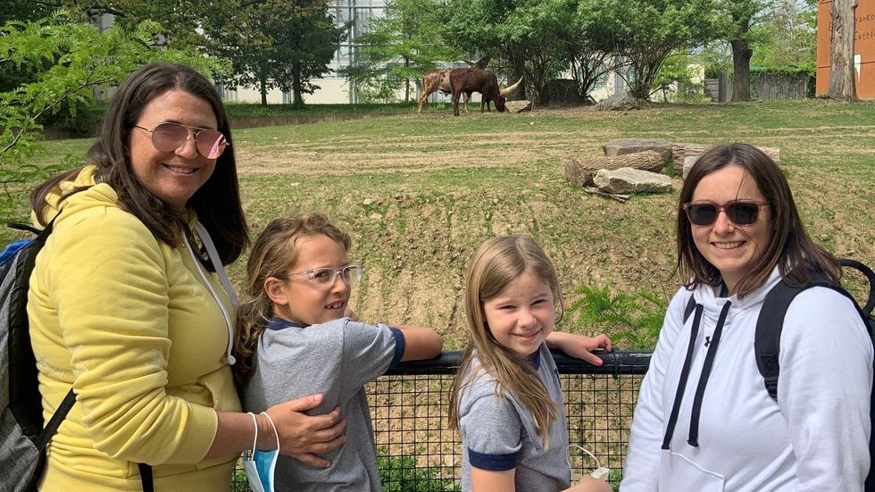 Madi Cyrus (second from left) with loved ones watching the Ankole cattle at the Philadelphia Zoo.