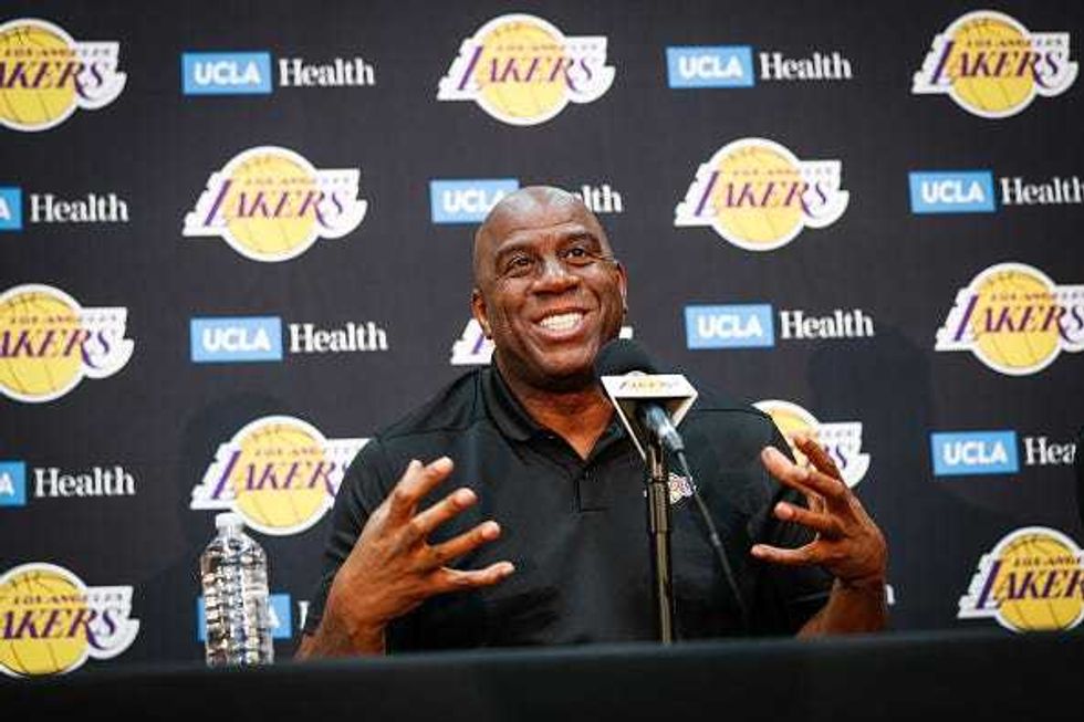 Magic Johnson speaks with reporters at a press conference.