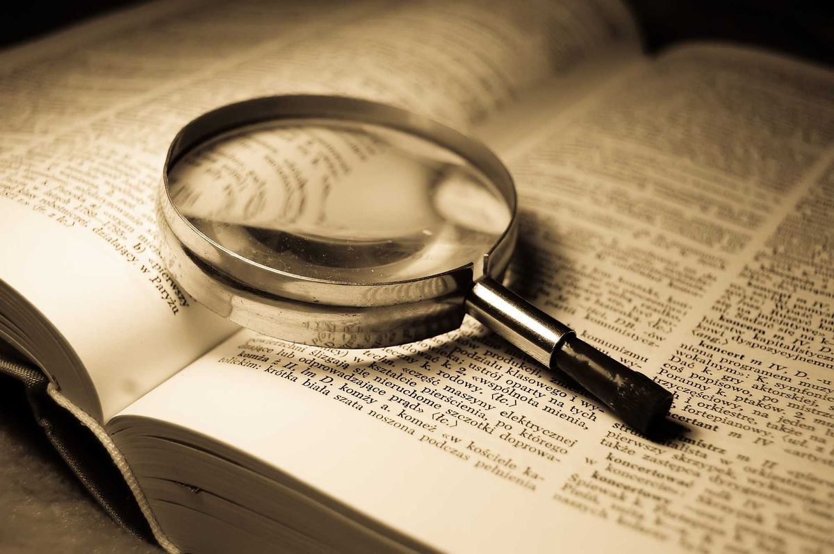 Magnifying glass on a dictionary.