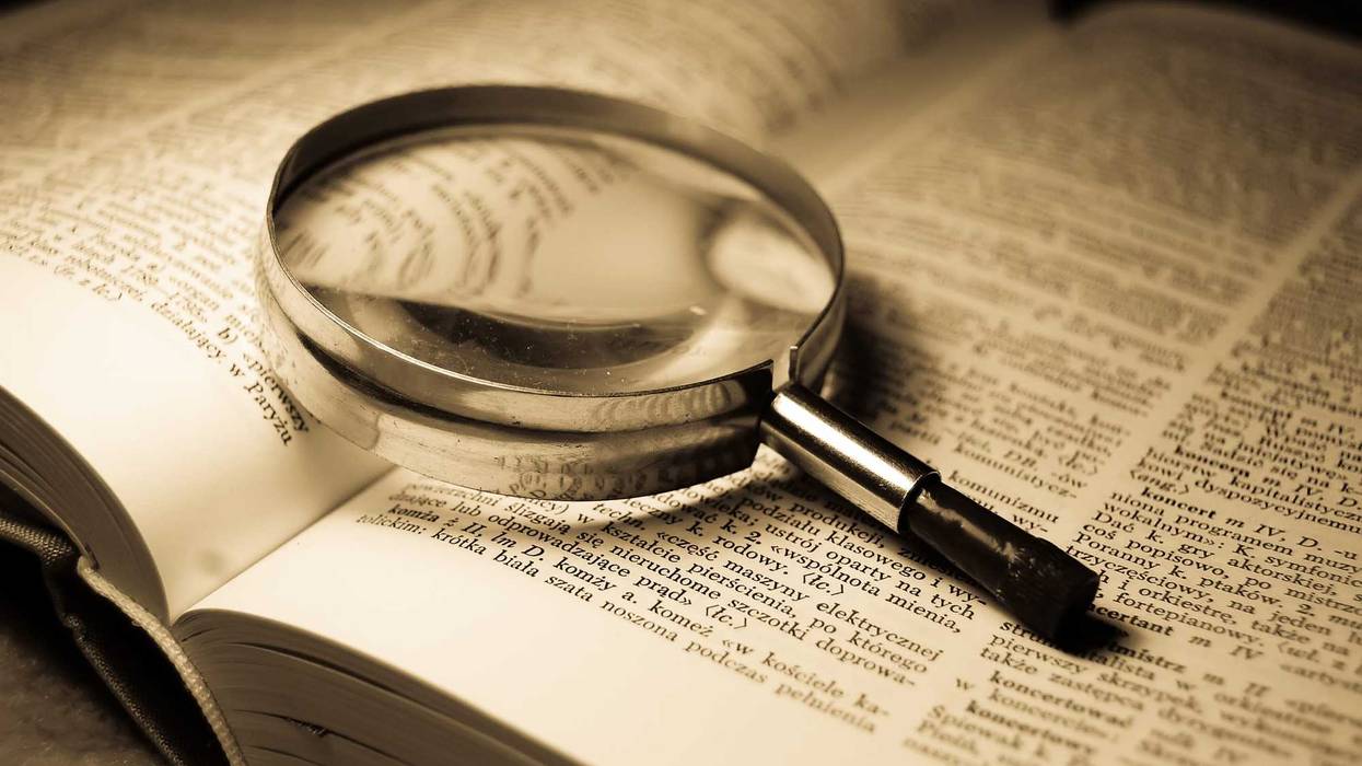 Magnifying glass on a dictionary.