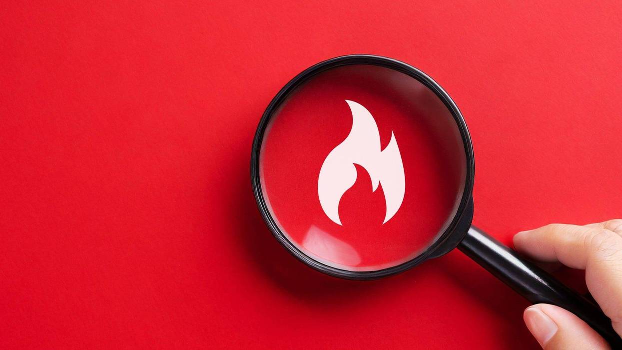 Magnifying glass with flame icon - stock photo