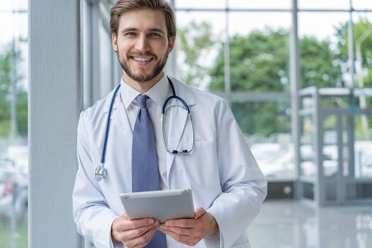 Male doctor using tablet in hospital