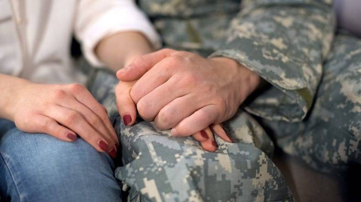 Male soldier holding girlfriends hand