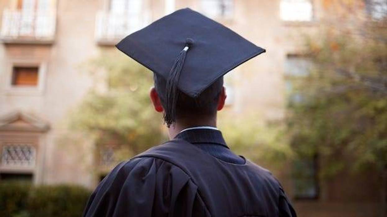 Male student wearing a graduation cap and robe
