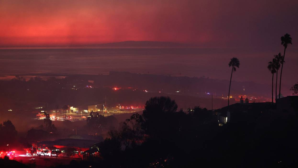 MALIBU, CALIFORNIA - DECEMBER 10: The Franklin Fire burns at dawn with the Pacific Ocean visible in the distance on December 10, 2024 in Malibu, California. The wildfire has scorched 1,800 acres near Pepperdine University prompting evacuations along the coast amid high winds with some structures destroyed.