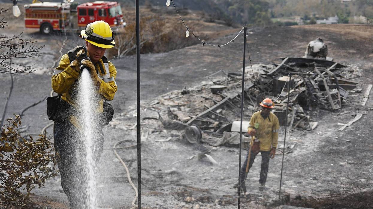 MALIBU, CALIFORNIA - DECEMBER 11: Los Angeles County Fire Department firefighters put out hotspots in an area which burned in the Franklin Fire on December 11, 2024 in Malibu, California. The wildfire has scorched 3,800 acres near Pepperdine University, destroying some homes and forcing thousands to evacuate along the coast amid high winds.