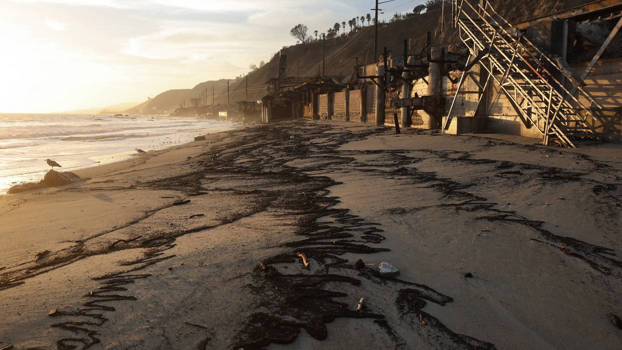 MALIBU, CALIFORNIA - FEBRUARY 18: Wildfire-related debris is washed up on the Pacific Ocean shoreline following recent heavy rains, near beachfront properties destroyed in the Palisades Fire, on February 18, 2025 in Malibu, California. Scientists are concerned about the long terms effects of the wildfires on the coastline as hazardous materials in storm runoff could potentially affect aquatic life.