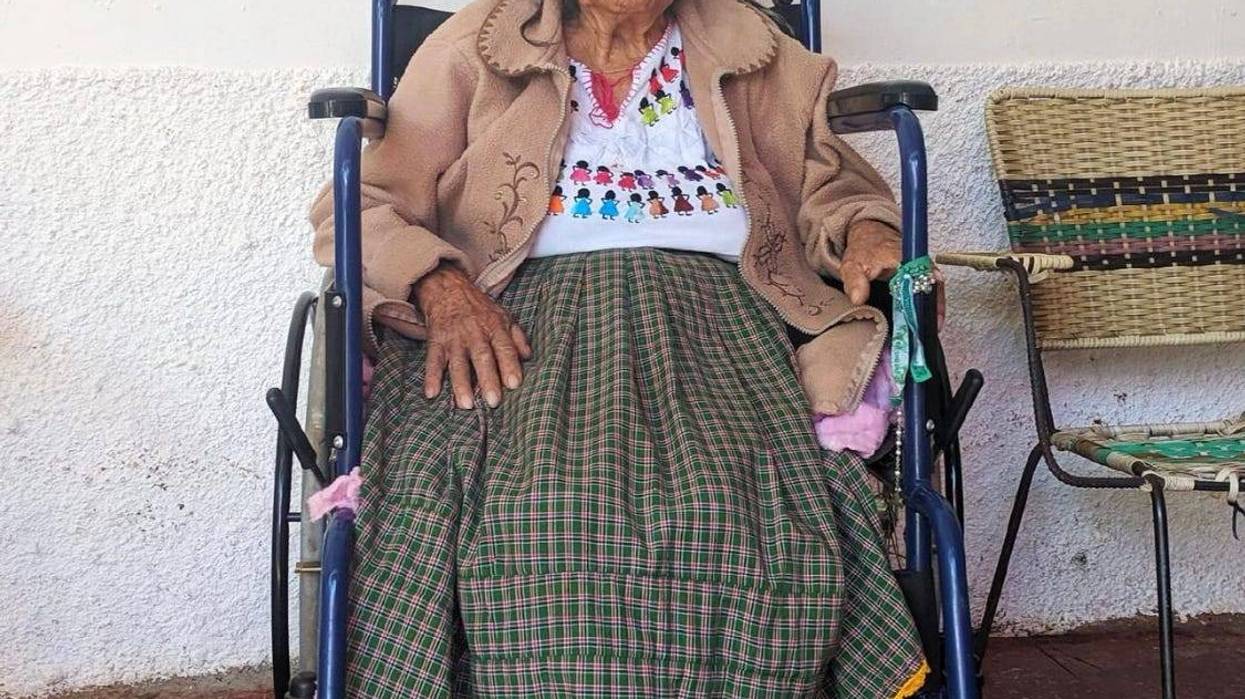 Mama Coco sitting on a wheels chair