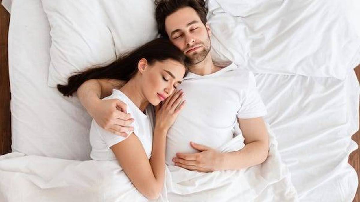 Man and woman cuddling in bed