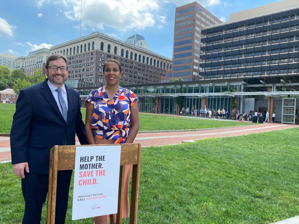 Man and woman standing in front of a podium