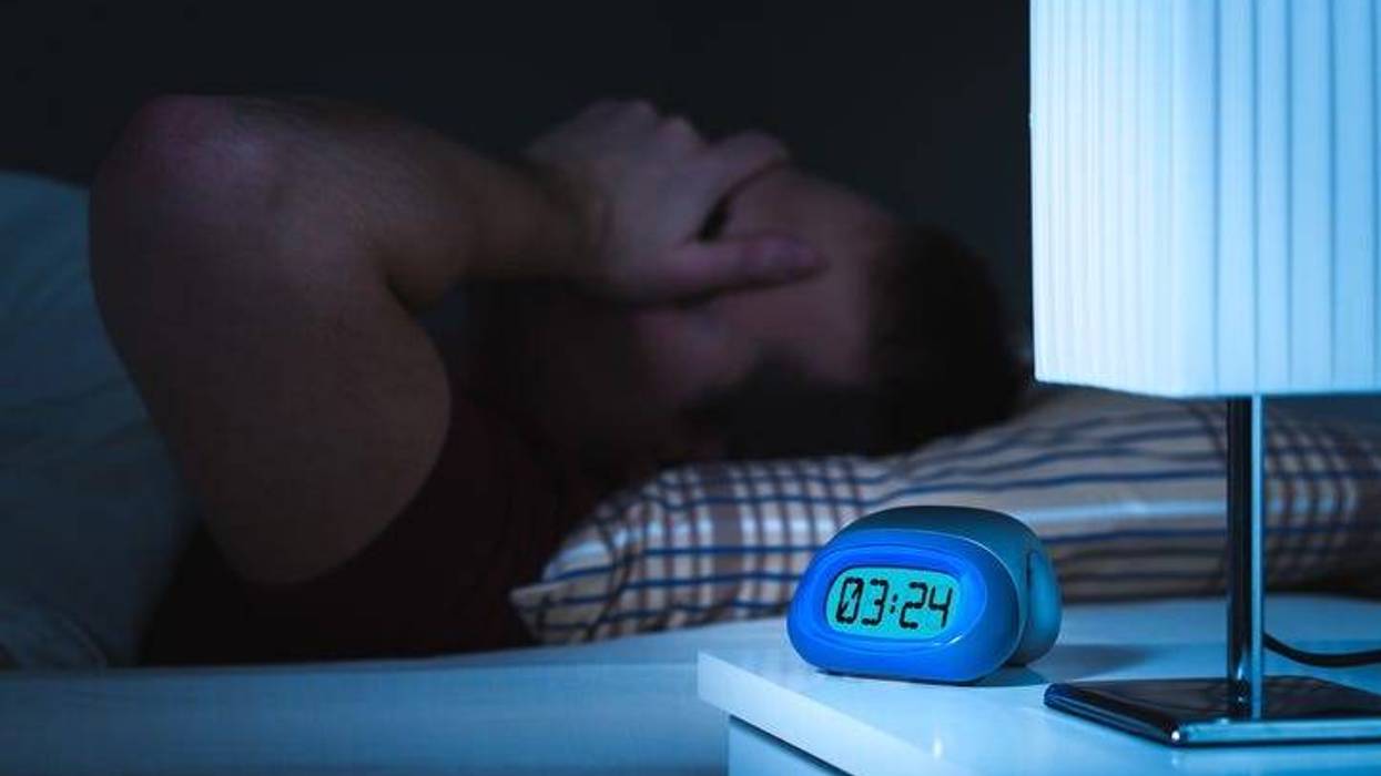 Man awake with clock reading 3am
