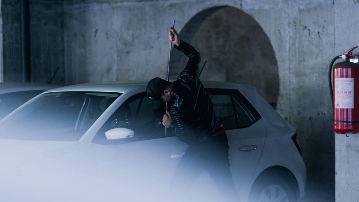 Man breaking into a vehicle