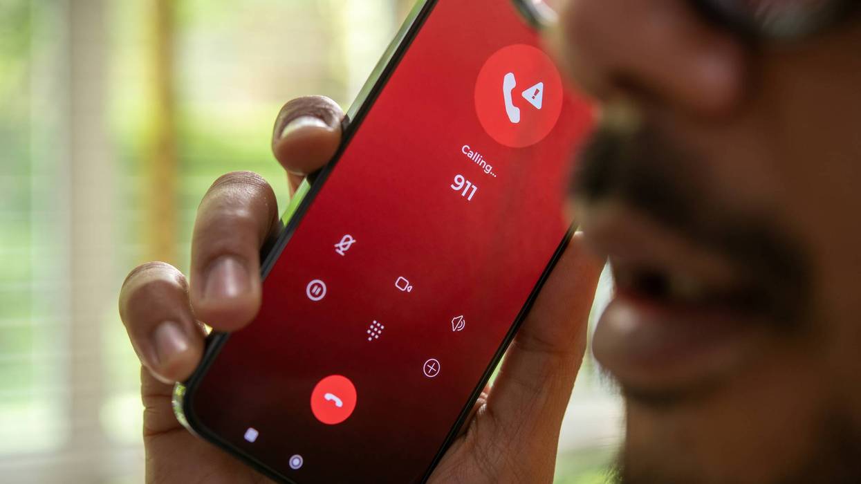 Man calling emergency number 911 for crisis situation