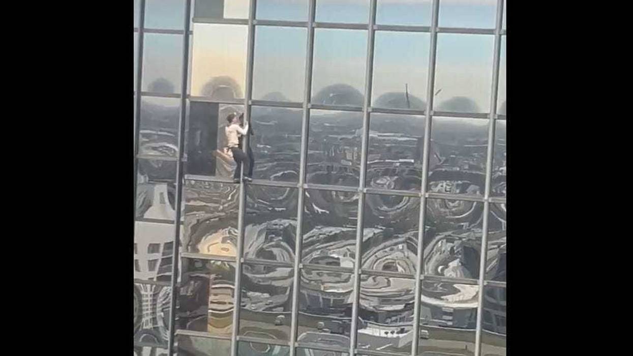 man climbing Accenture Tower